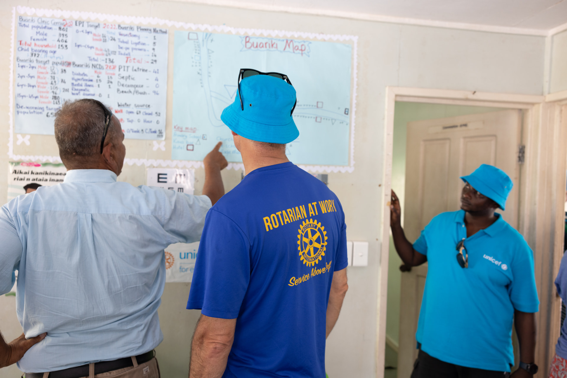 Rotary and UNICEF volunteers reviewing a village health map