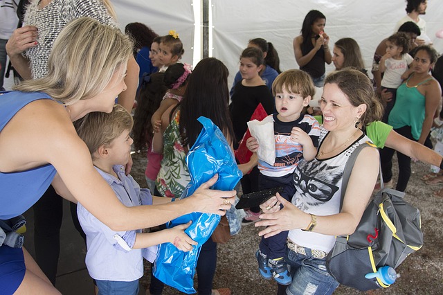 Volunteers handing out supplies to families and children